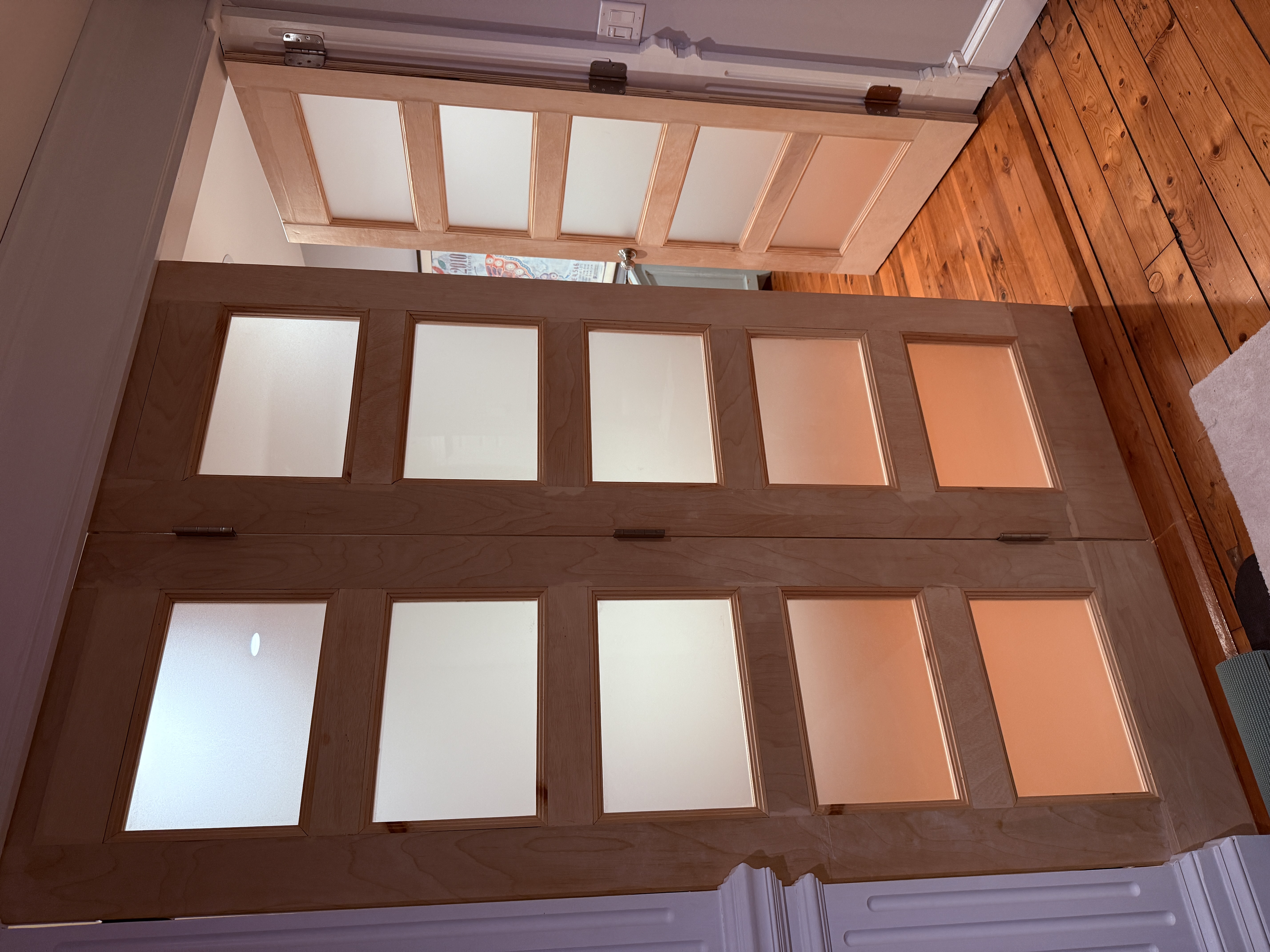 Custom accordion doors with frosted glass panels and custom hardware in South Kingstown, RI