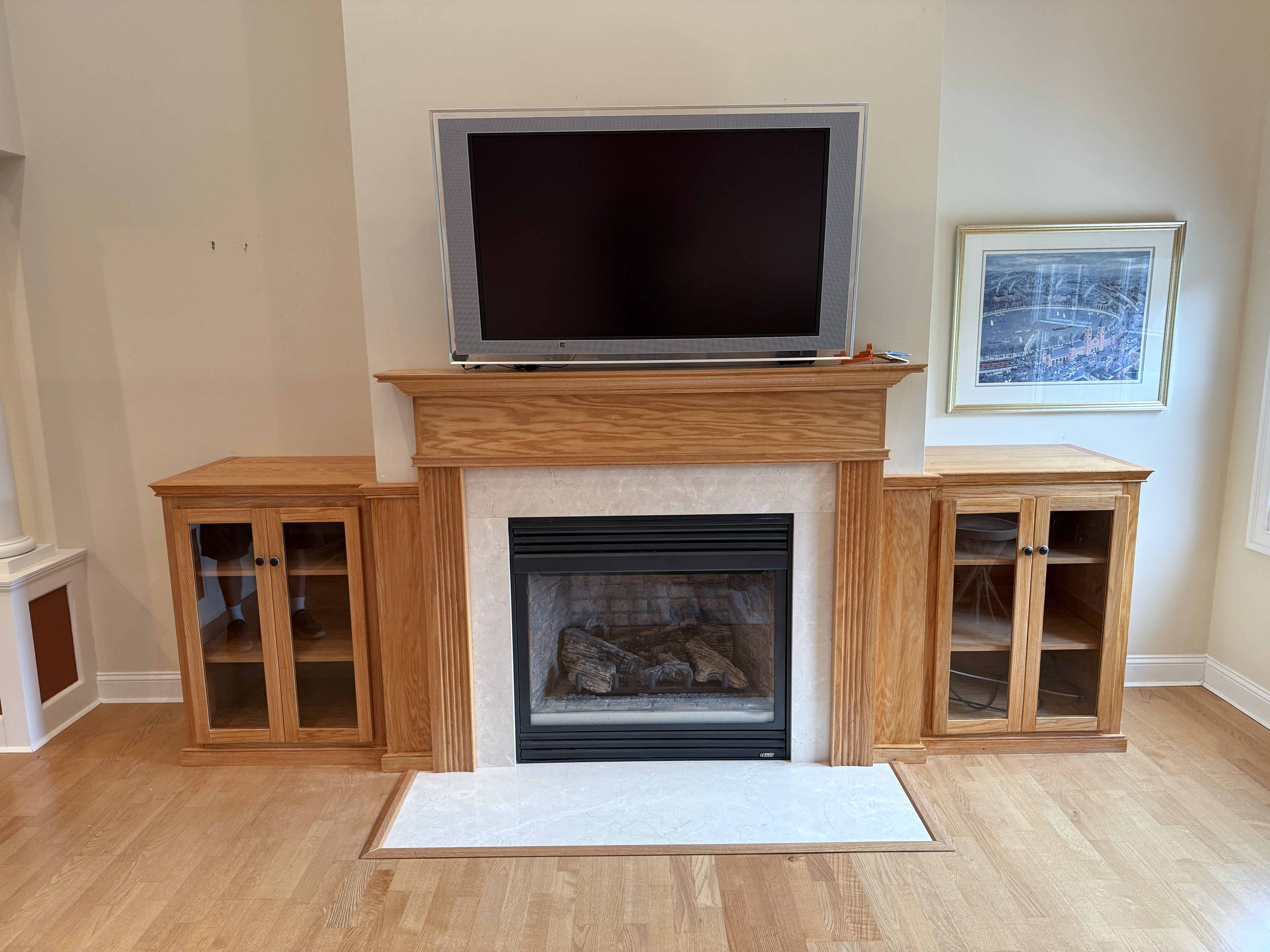 Custom oak built-in cabinets flanking a fireplace in a Narragansett, Rhode Island home