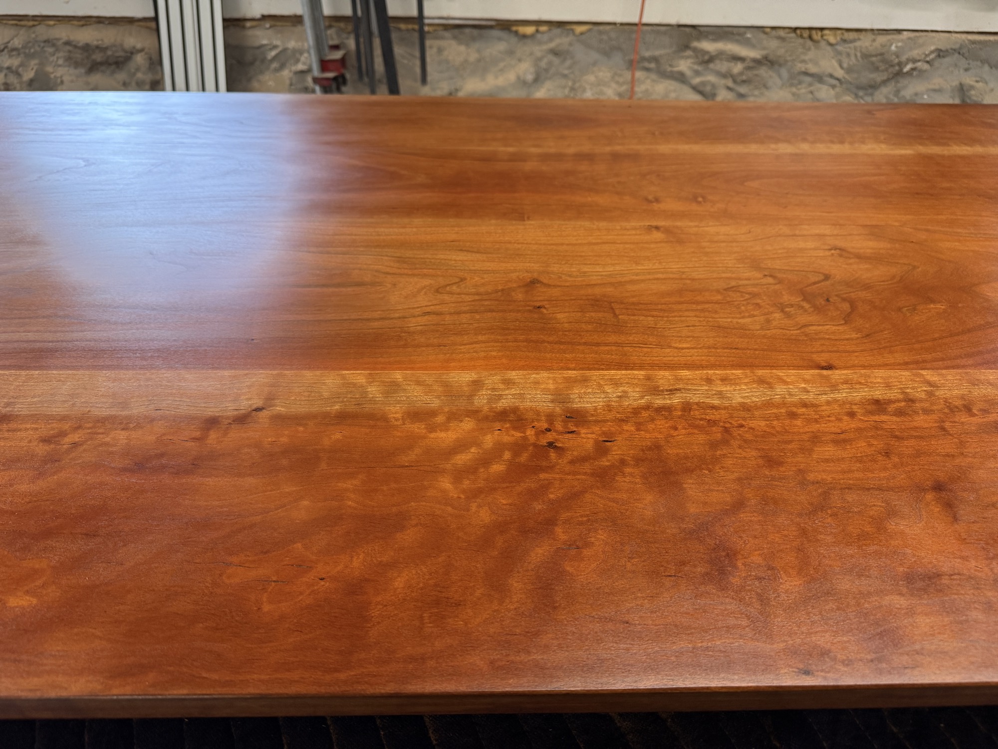 Refinished hardwood dining tabletop with an even glossy finish, refinished for a Wakefield, RI home